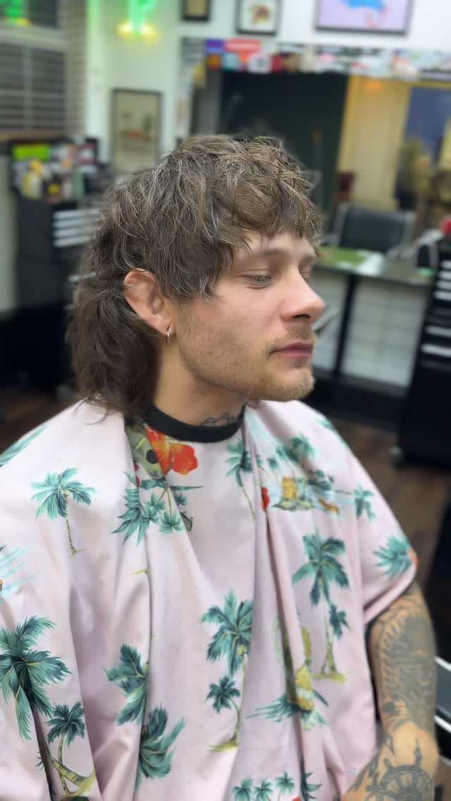 One of Ken’s clients in the chair at Black Panther, long textured hair and a beard