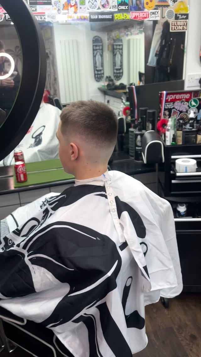 A short fade from behind in one of the Black Panther chairs